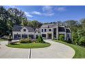 Stately home with a three-car garage, circular drive and professionally landscaped lawn at 700 N Island Dr, Atlanta, GA 30327