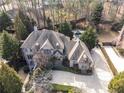 Aerial view of house with a large backyard, lush landscaping, and a pristine pool at 3871 Trickum Road Ne, Marietta, GA 30066