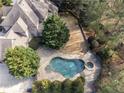 A pristine swimming pool with a spa is nestled in a private backyard oasis surrounded by lush greenery at 3871 Trickum Road Ne, Marietta, GA 30066