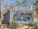 Expansive backyard with a spacious deck and lush greenery, perfect for outdoor entertaining at 990 Ivy Falls Dr, Atlanta, GA 30328