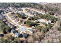 Aerial view of a residential neighborhood showcasing homes nestled among trees with a winding road system at 201 Chert Way, Atlanta, GA 30349