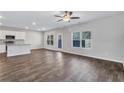 Bright, open-concept living room with hardwood floors, complemented by neutral paint and ample natural light at 201 Chert Way, Atlanta, GA 30349
