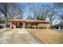 Well-kept single-story brick home with a covered carport and a spacious driveway at 2631 Miriam Ln, Decatur, GA 30032