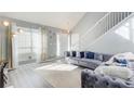 Sun-filled living room featuring a vaulted ceiling, white railing, and stylish gray sofa at 4119 Ravenwood Ct, Union City, GA 30291