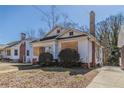 Exterior shot of boarded house with small yard and brick foundation and chimney at 1046 Katherwood Sw Dr, Atlanta, GA 30310