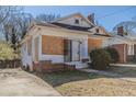 Exterior shot of boarded house with small yard and brick foundation and chimney at 1046 Katherwood Sw Dr, Atlanta, GA 30310