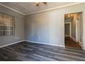 Renovated room with gray walls, light trim, new gray vinyl floor, and window at 1046 Katherwood Sw Dr, Atlanta, GA 30310