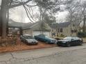 View of the rear of the home with an attached garage and three cars parked in front at 1779 South Gordon Sw St, Atlanta, GA 30310
