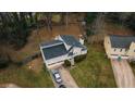 Home with attached garage, surrounded by mature trees on a grassy lot at 3981 Rocmar Dr, Snellville, GA 30039