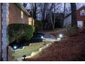 Exterior view with landscaped retaining wall with steps leading up to the main house at 1285 Glandor Se Ct, Mableton, GA 30126