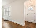 Bright foyer featuring a white front door with a decorative window, wood floors and white trim at 2876 Alpine Ne Rd, Atlanta, GA 30305