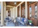 Inviting porch featuring a cozy seating area with stylish furniture and elegant wood and glass doors at 440 Belada Blvd, Sandy Springs, GA 30342