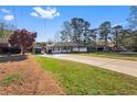 View of the home's inviting exterior, complete with a long driveway and well-maintained front yard at 409 Shannon Way, Lawrenceville, GA 30044