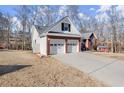 Charming brick home featuring a two-car garage and a well-maintained front lawn with a view of the backyard at 2720 Araglin Dr, Dacula, GA 30019