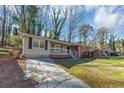 Charming single-story home featuring a brick facade, front porch, and well-maintained lawn, blending classic charm with modern comfort at 2084 Snow Sw Rd, Atlanta, GA 30311