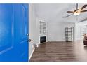 Open living room with a fireplace, stylish shelving, and hardwood flooring at 5336 Monticello Dr, Villa Rica, GA 30180