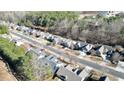 An aerial view of a quiet neighborhood showcases rows of well-maintained homes nestled among mature trees at 903 Creek Bottom Rd, Loganville, GA 30052