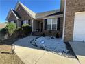 Charming entrance of a brick home enhanced by decorative stone landscaping, and an ADT security sign at 903 Creek Bottom Rd, Loganville, GA 30052