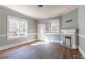 Sunlit living room with beautiful hardwood floors, a decorative fireplace, and a classic design at 1126 Indale Sw Pl, Atlanta, GA 30310