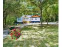 Charming home with a landscaping allowance, features a well-maintained yard and mature trees at 243 Howell Sw Ter, Atlanta, GA 30331