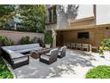 Beautiful outdoor patio features comfortable seating around a fire pit and dining area for entertaining at 2525 Peachtree Ne Rd # 32, Atlanta, GA 30305