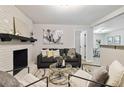 Comfortable living area with a painted brick fireplace and contemporary furniture at 839 Kennesaw Dr, Forest Park, GA 30297