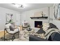 Bright living room has a painted brick fireplace and a neutral color scheme at 839 Kennesaw Dr, Forest Park, GA 30297
