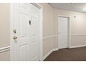 Hallway with neutral paint and carpet leads to apartments, providing a simple yet functional entrance at 1501 Clairmont Rd # 1024, Decatur, GA 30033