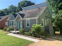 Gray brick home featuring a unique blue door and landscaped front yard at 2569 Northview Ave, Decatur, GA 30032
