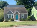 Gray brick home featuring a unique blue door and well-maintained front yard at 2569 Northview Ave, Decatur, GA 30032