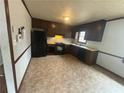Functional kitchen with dark wood cabinets, black appliances, and laminate countertops at 1789 Riverridge Nw Dr, Conyers, GA 30012