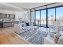 Open concept with spacious living room featuring floor-to-ceiling windows and modern kitchen at 2425 Peachtree Nw Rd # 1802, Atlanta, GA 30305