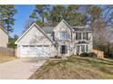 Charming two-story home with a well-maintained lawn and attached two-car garage at 5320 Taylor Rd, Johns Creek, GA 30022