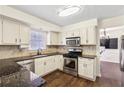 Well-lit kitchen with stainless steel appliances, granite countertops, and tile backsplash at 5320 Taylor Rd, Johns Creek, GA 30022