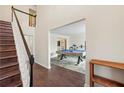 Elegant staircase with dark wood steps and white railing, leading to an open entryway at 5320 Taylor Rd, Johns Creek, GA 30022