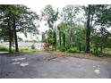Wide driveway area with trees and partial view of neighboring house at 4011 Florida Ave, Atlanta, GA 30360