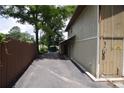 Side view of the home featuring a long driveway and fenced yard at 4011 Florida Ave, Atlanta, GA 30360