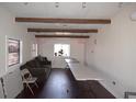 This living room features white walls, dark wood flooring, exposed beams, and ample space for versatile arrangements at 4011 Florida Ave, Atlanta, GA 30360
