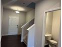 Bright hallway leading to stairs, white trim and doors and a half bathroom on the first floor at 684 Sundial Ln, Mableton, GA 30126