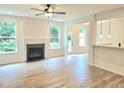 Spacious living room with a cozy fireplace, large windows, and open layout perfect for entertaining at 684 Sundial Ln, Mableton, GA 30126