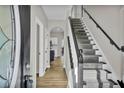 Inviting home entryway with hardwood floors, staircase, and view into the kitchen at 1021 Crooked Creek Se Ct, Mableton, GA 30126