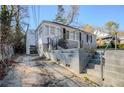 Exterior view of the back of this single story home showing the steps and retaining wall at 1810 Oakmont Nw Dr, Atlanta, GA 30314