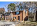 Brick townhome features a traditional design with a front parking lot and lamppost at 4526 Golf Vista Cir, Decatur, GA 30035