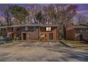Brick townhome during sunset features a traditional design with a front parking lot at 4526 Golf Vista Cir, Decatur, GA 30035