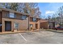 Brick townhome features a traditional design with a front parking lot on a sunny day at 4526 Golf Vista Cir, Decatur, GA 30035