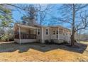 Single story home with a large, covered porch and a nice backyard, perfect for relaxation and outdoor activities at 5498 Balmoral Dr, Douglasville, GA 30135