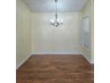 Bright dining area featuring wood floors and a modern chandelier at 682 New England Way, Lawrenceville, GA 30046