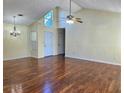 Well-lit living room with vaulted ceilings, hardwood floors, and modern light fixtures at 682 New England Way, Lawrenceville, GA 30046