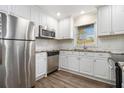 Modern kitchen with stainless steel appliances, granite countertops, white cabinets and subway tile backsplash at 1961 S Columbia, Decatur, GA 30032