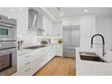 Modern kitchen featuring stainless steel appliances, an island with chairs, and sleek white cabinets at 2425 Peachtree Ne Rd # 903, Atlanta, GA 30305
